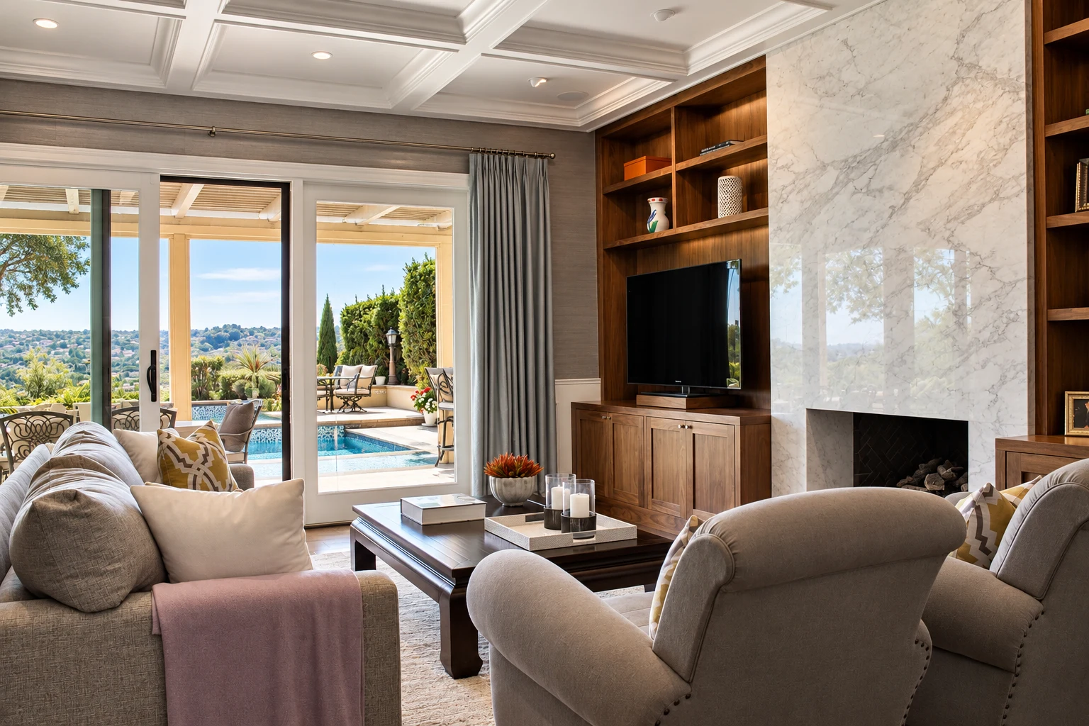 Comfortable living room with custom shelving, a stone fireplace, and garden views
